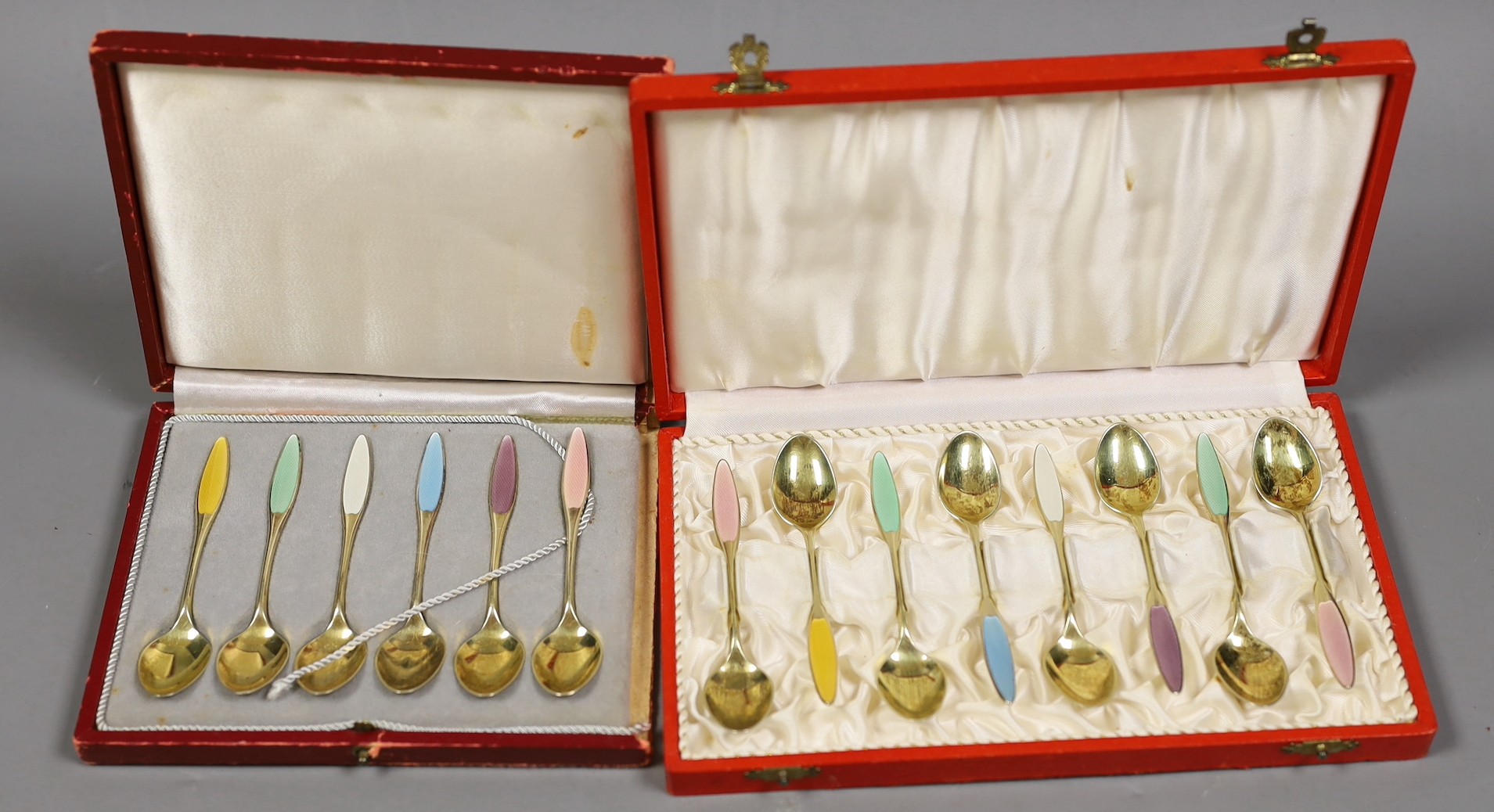 A cased set of eight Danish gilt sterling and polychrome enamelled coffee spoons and a similar cased set of six coffee spoon.